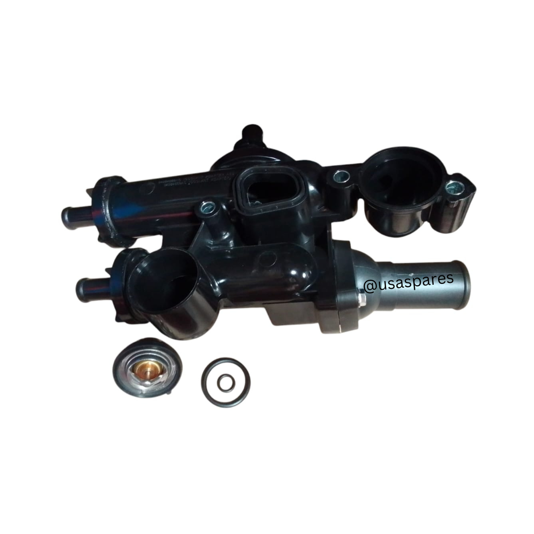 Close-up image of a new Dodge Caliber Thermostat Housing / Water Outlet, showing its durable construction, precision mounting points, and coolant hose connections for effective engine temperature regulation.