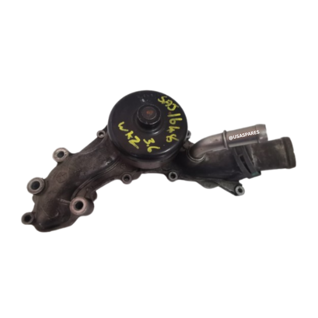 Used Chrysler 300C 3.6 water pump in working condition, OEM fit, tested for leaks and wear, ideal for engine cooling system repair or replacement.