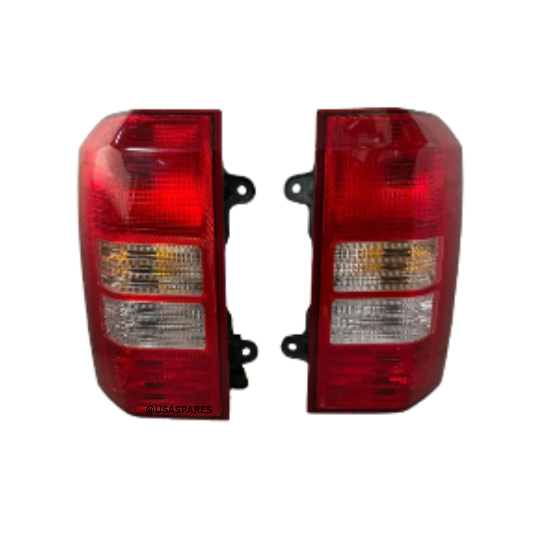 Used OEM Jeep Patriot tail lights for 2007–2017 models, showing red brake lenses with clear reverse sections in good condition.