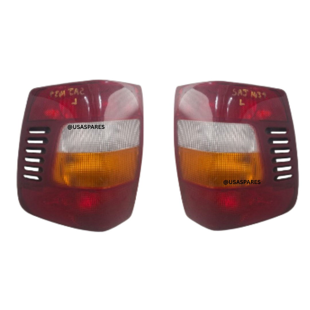 Close-up view of used Jeep Grand Cherokee 2.7 WJ 2004 tail lights showing intact lenses and original housing for rear vehicle lighting replacement.
