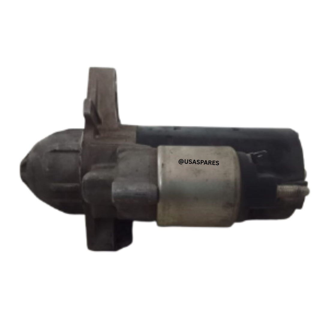 Used Jeep Grand Cherokee 3.0 WK2 Starter motor showing mounting points and electrical terminals, ready for replacement or repair.