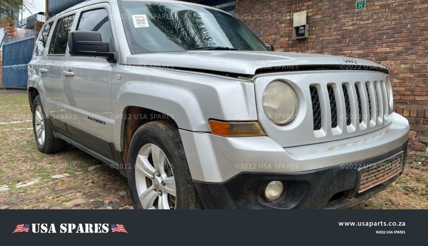 Image of 2014 Jeep Patriot 2.4 Manual Petrol stripping for spares, showing a vehicle being dismantled with various used parts available for resale including engine, body, and interior components.