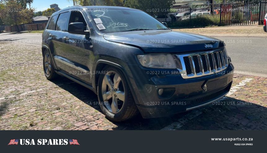 Image of 2013 Jeep Grand Cherokee 5.7 WK2 Automatic Petrol stripping for spares, showing a dismantled vehicle with various used parts available including engine components, body panels, and interior features.