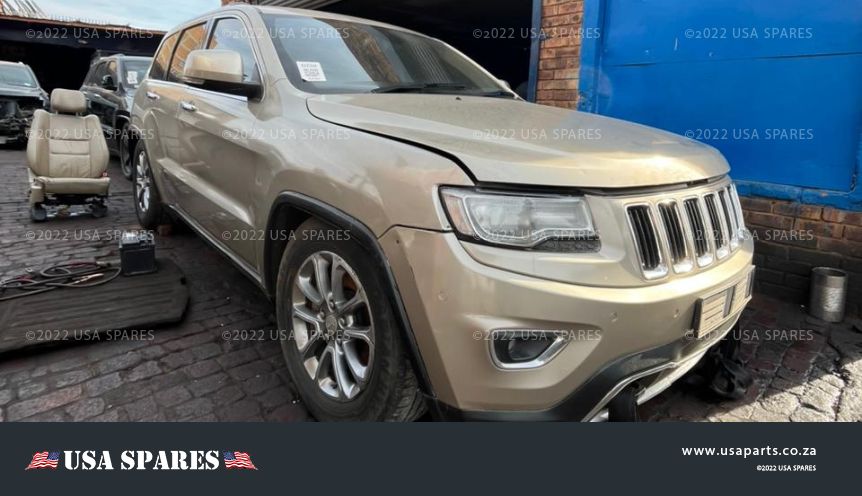 Image of 2013 Jeep Grand Cherokee 3.0 WK2 Automatic Diesel stripping for spares, showing dismantled vehicle components including engine parts, body panels, suspension, and interior items available for resale.