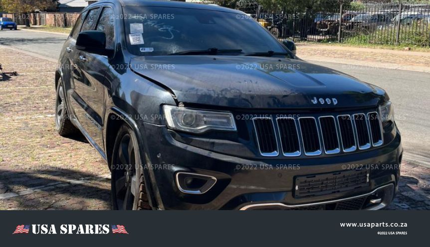 Image of 2014 Jeep Grand Cherokee 3.0 WK2 Automatic Diesel stripping for spares, showing dismantled vehicle components including engine parts, body panels, suspension, and interior items available for resale.
